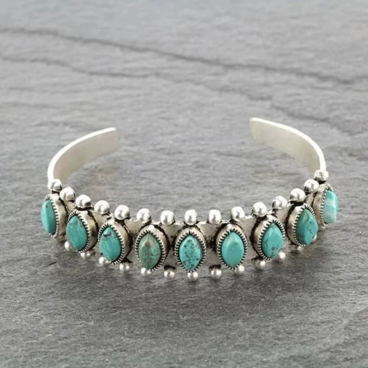 Öppet armband med turkosa detaljer
